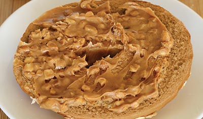 Schmear nut butter, hummus, or avocado on half a whole-grain bagel. 