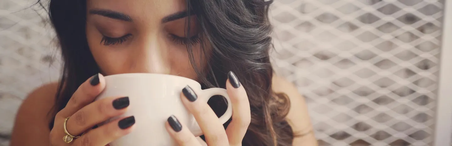 a woman drinking coffee