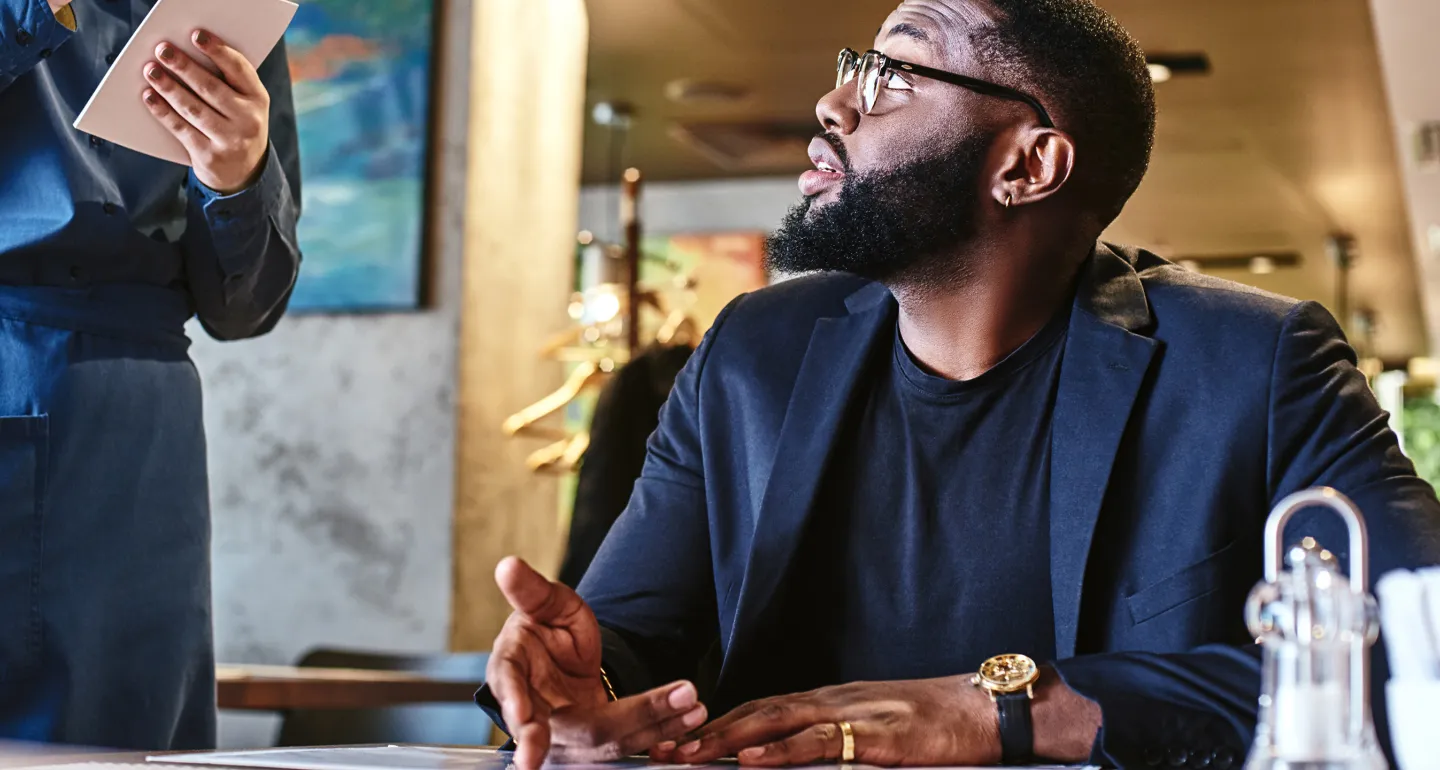 Person reading menu at a restaurant