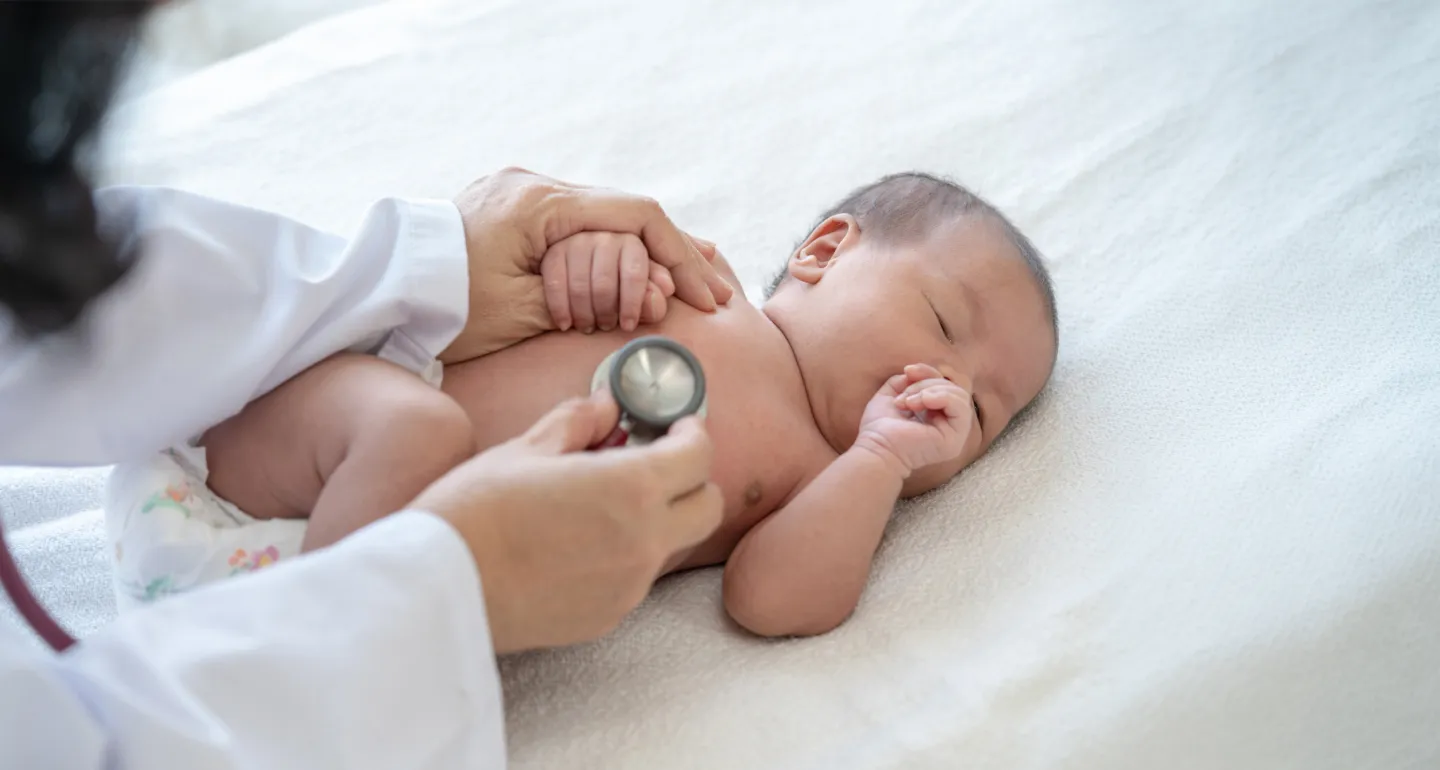 a baby being examined by a doctor
