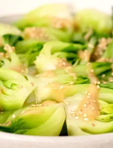 steamed bok choy with sesame sauce drizzled on top