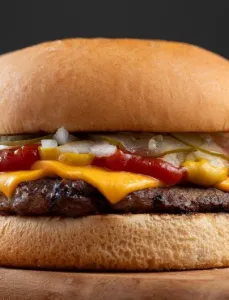 Classic burger with cheese, onions, pickle, mustard, and ketchup