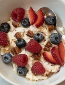white bowl with berries and overnight oats