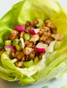 lettuce cup filled with various vegetables and tempeh