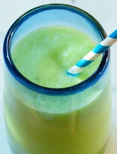 clear glass with blue rim filled with a light green drink