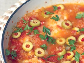 fish submerged in tomato based sauce