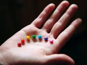 Brightly colored star-shaped sprinkles in a child's hand