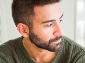 man in green shirt looking to his left