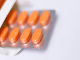 A blister pack of red oblong pills