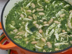 large orange ceramic pot filled with green chicken chili