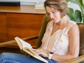 Woman reading book on couch