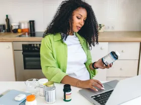 A woman researching supplements on her laptop