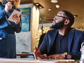 Person reading menu at a restaurant