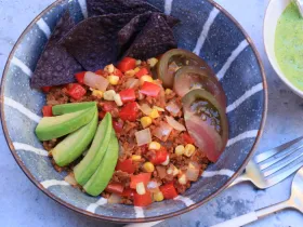striped blue bowl with chopped vegies and avocado
