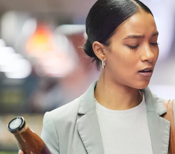A woman reading product packaging