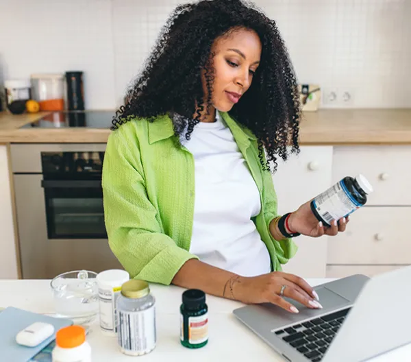 A woman researching supplements on her laptop