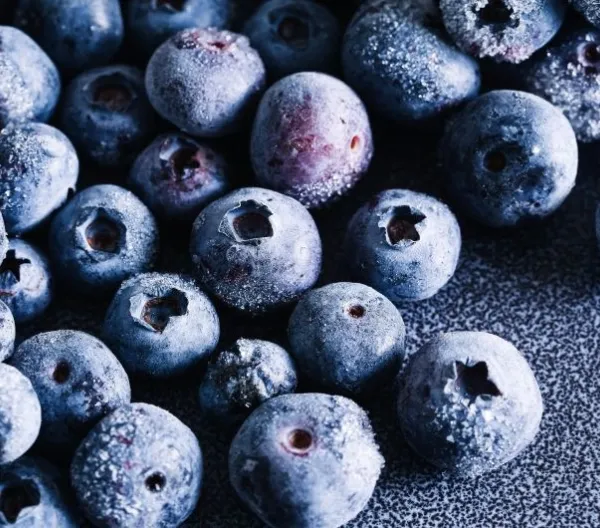Frozen blueberries closeup with frost texture