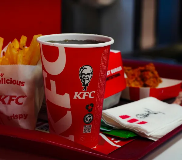A KFC meal prominently featuring a fountain soda