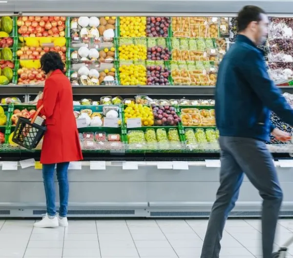 At the Supermarket: Woman Chooses Organic Fruits in the Fresh Produce Section of the Store