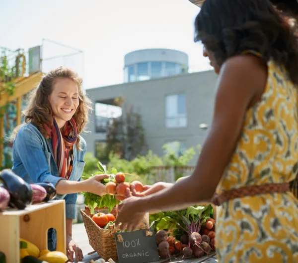 women buying and selling at a farmer's market