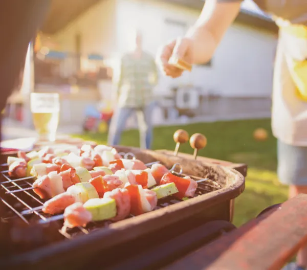 person grilling in evening sunlight