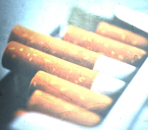 open pack of cigarettes with filter over it