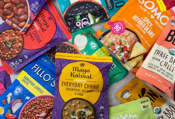 pile of pouches of pre-seasoned beans and lentils