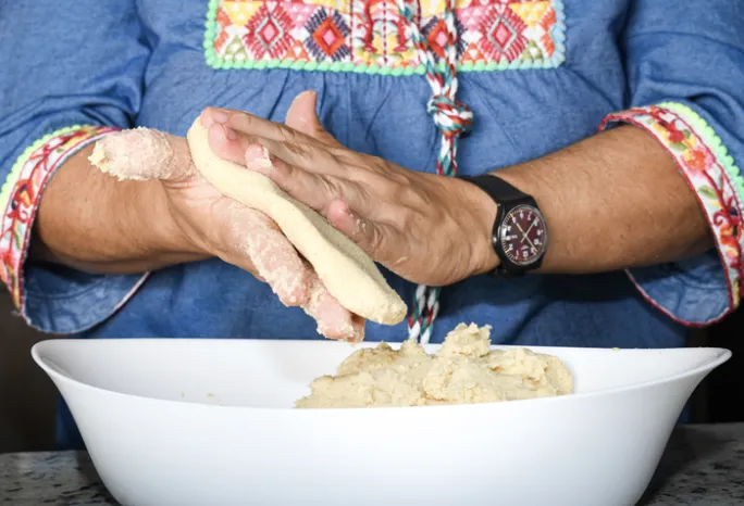 woman's hands making a corn flour tortilla