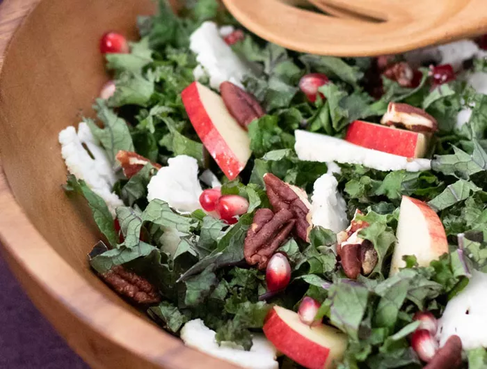 salad with kale, apples, pecans, and pomegranate