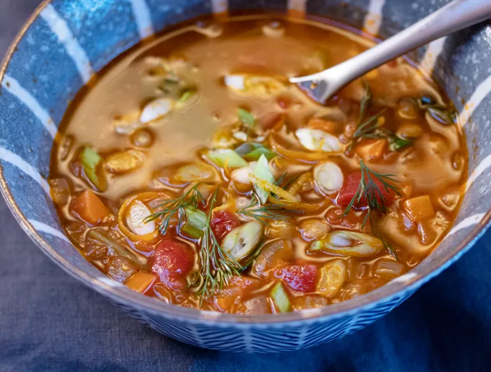 a bowl of greek lentil soup