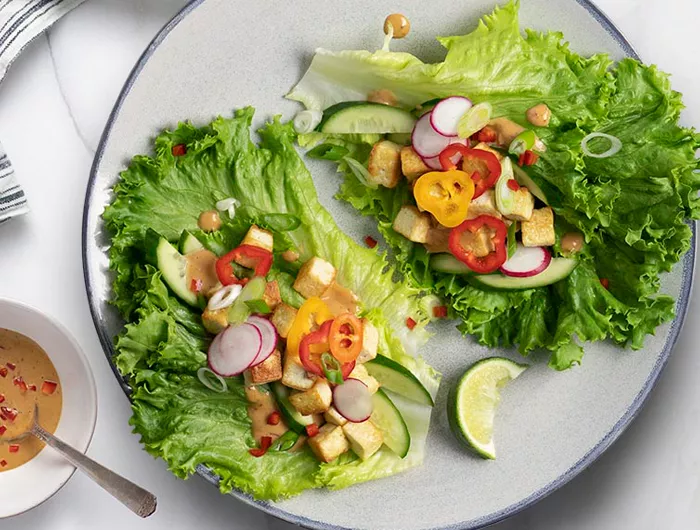 a plate of peanut lettuce wraps