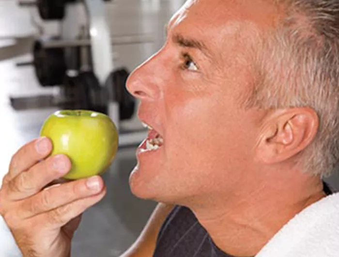 man biting into apple