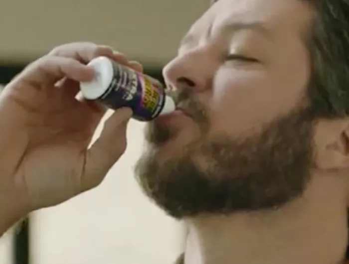 man drinking energy shot