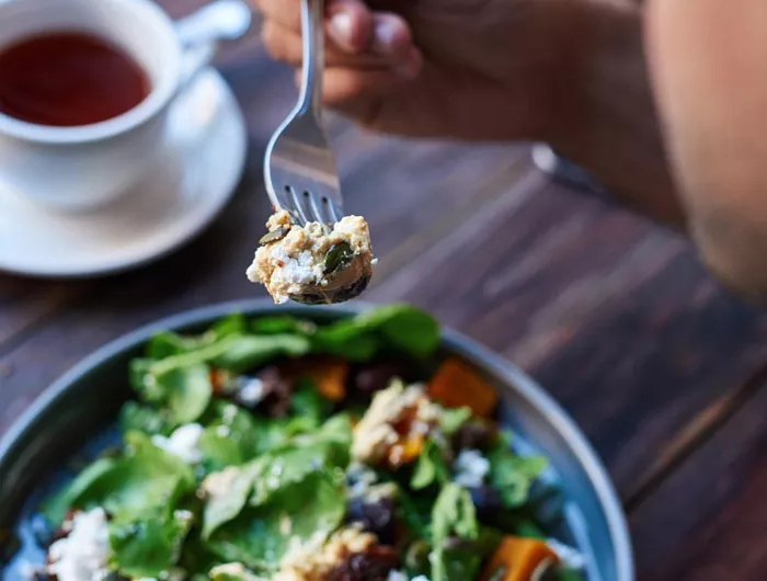 fork over a plate of salad