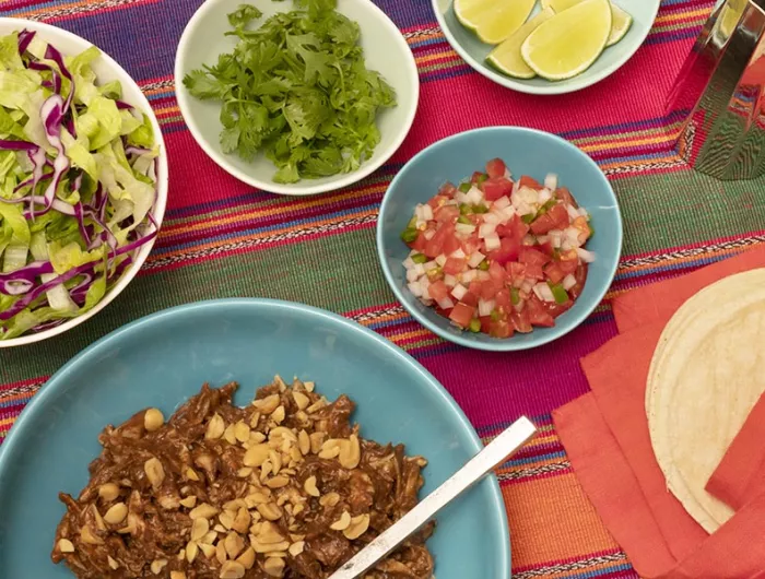 chicken mole with lettuce, cilantro, pico de gallo, and lime wedges