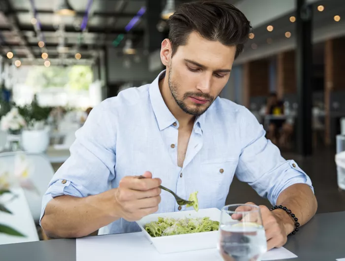 man eating pasta