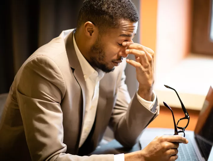 Man holding bridge of nose