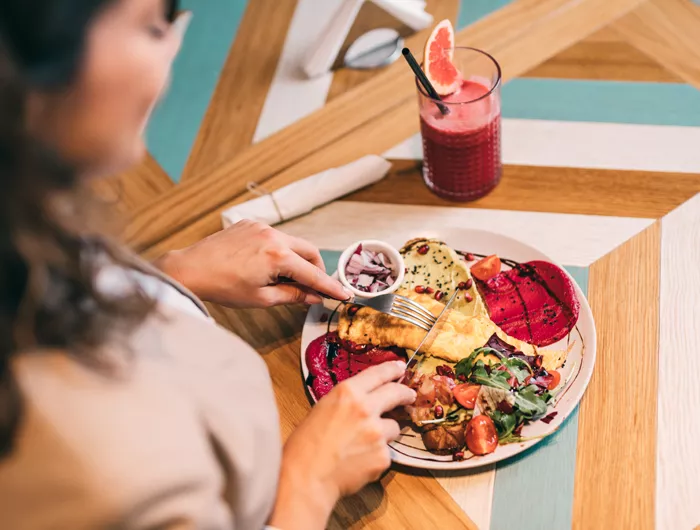 woman eating off full plate of food