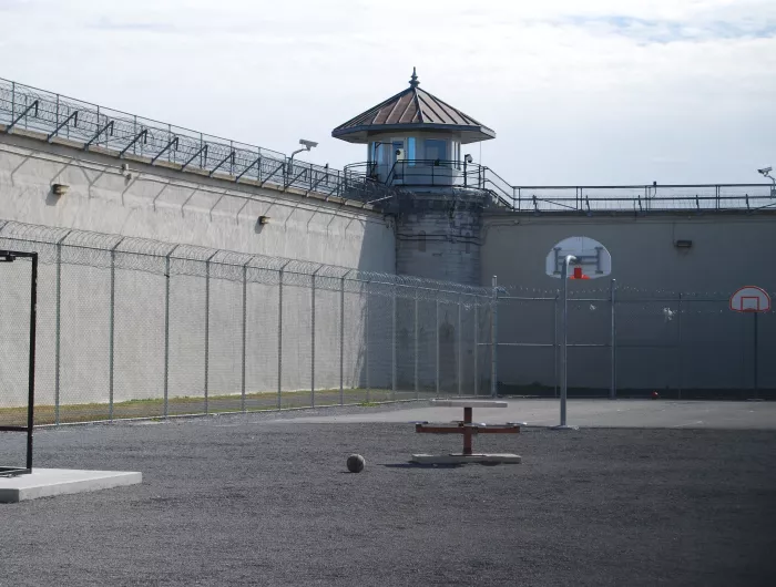 Empty prison courtyard with basketball