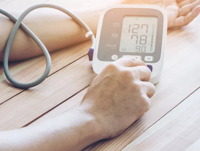 a person using an at home bp monitor