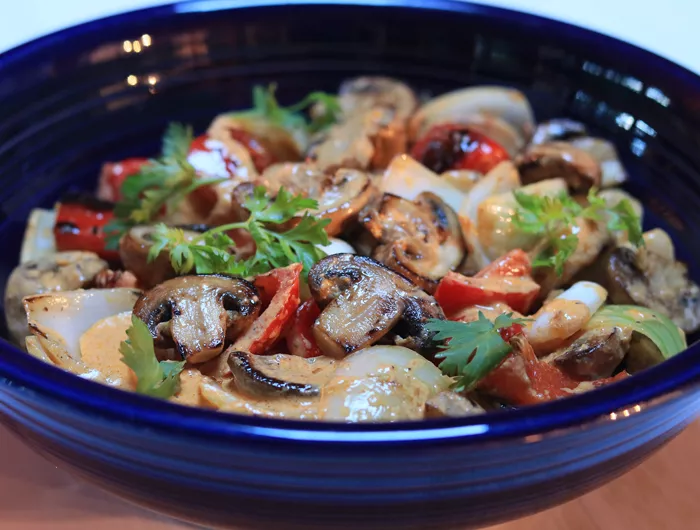 blue bowl with mushrooms and other veggies mixed 