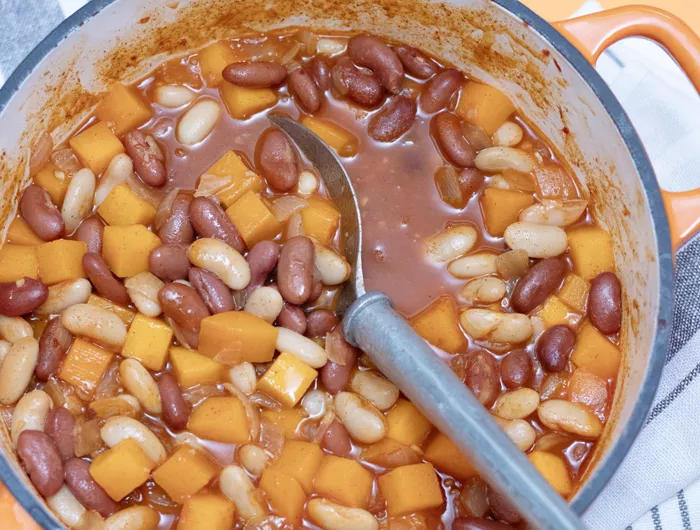 large pot of stew with a grey spoon in the pot