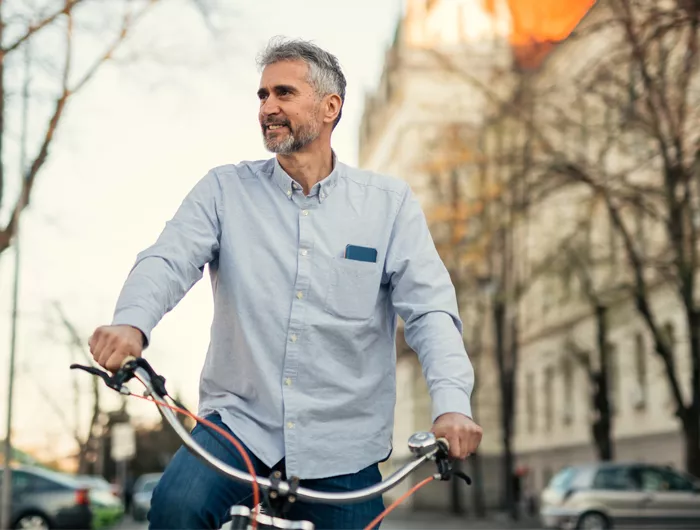 man on a bike riding through a city