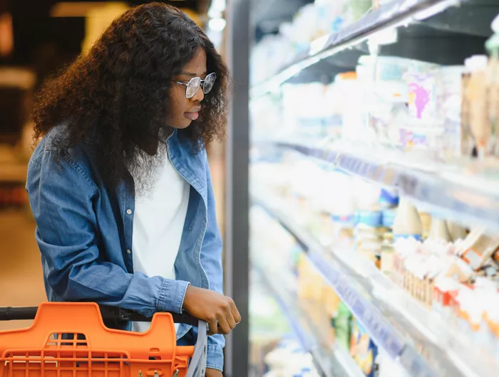 Person looking at yogurt on store 