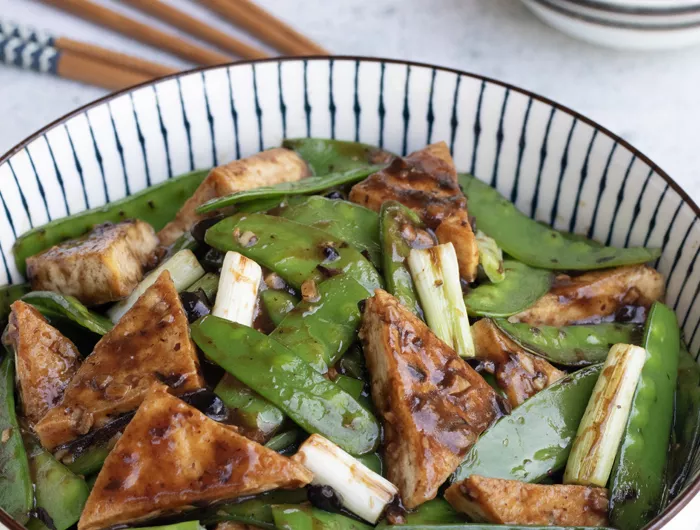 bow of tofu triangles and snow peas with scallions and garlic