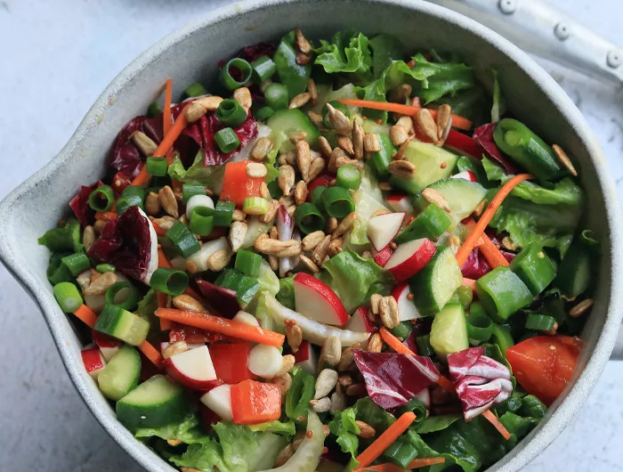 large bowl of salad with chopped lettuce and other vegetables