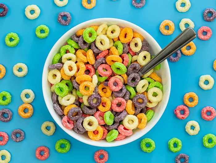 Colored breakfast cereal in a bowl on a blue background