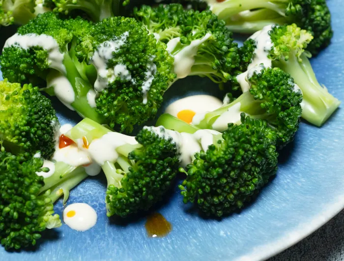 blue plate with broccoli and Caesar sauce