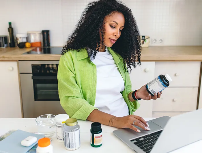 A woman researching supplements on her laptop