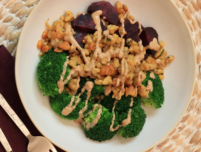 bowl of crispy tempeh, broccoli and purple sweet potato